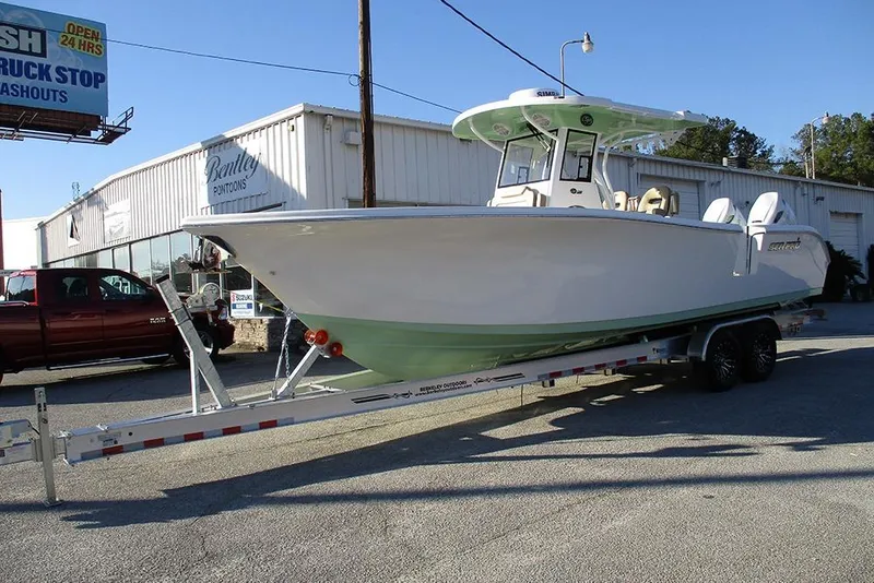Slide: The Image of 2026 Sea Pro 292 Offshore boat on trailer outside Bentley Pontoons dealership. - 3