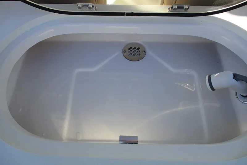 Slide: The Image of Livewell on 2026 Sea Pro 292 Offshore boat, featuring a drain and water inlet. - 42