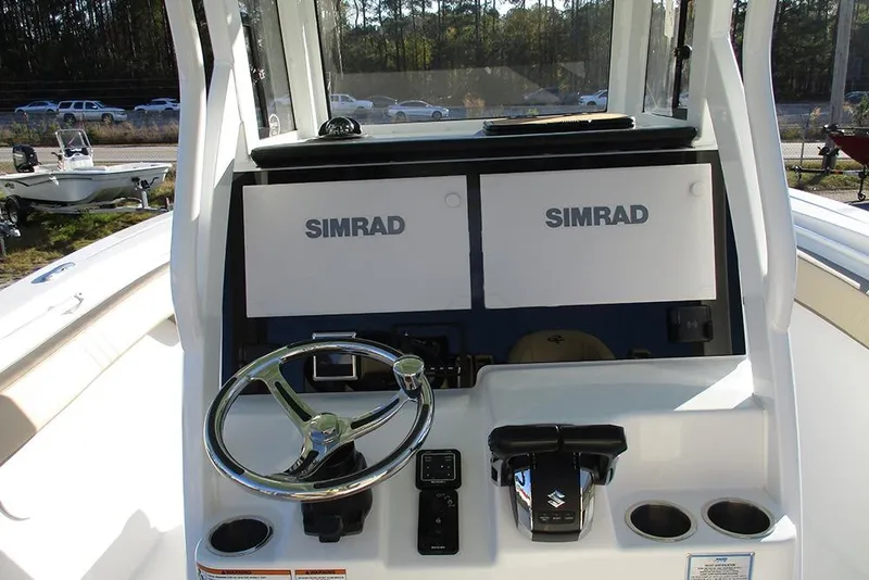 Slide: The Image of 2026 Sea Pro 292 Offshore boat dashboard with dual Simrad displays and steering wheel. - 47