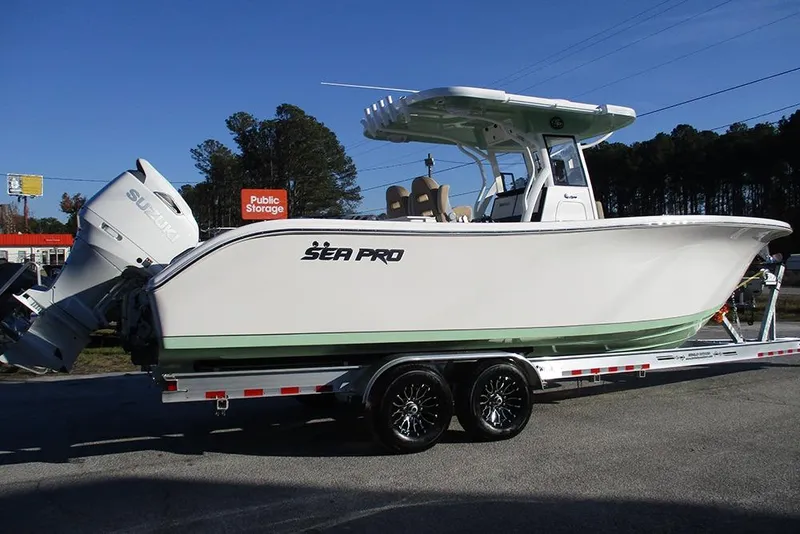 Slide: The Image of 2026 Sea Pro 292 Offshore boat on trailer, featuring Suzuki outboard engine. - 6