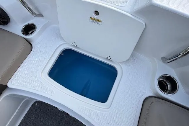 Slide: The Image of 2025 Tahoe 2150 boat interior with storage compartment and cup holders. - 11