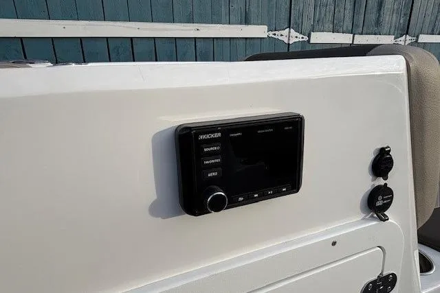Slide: The Image of Control panel of a 2025 Tahoe 2150 boat featuring a Kicker audio system. - 14