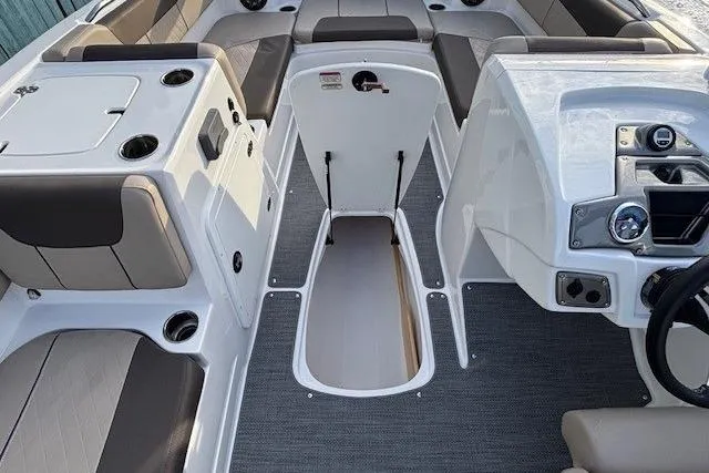 Slide: The Image of 2025 Tahoe 2150 boat interior with seating, storage, and control panel. - 17