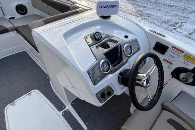 Slide: The Image of 2025 Tahoe 2150 boat dashboard with steering wheel and navigation system. - 19
