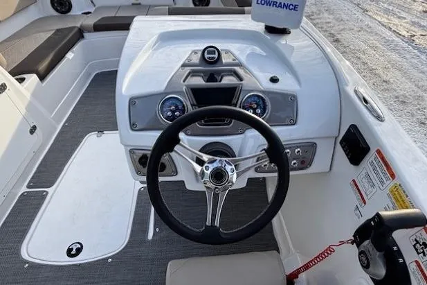 Slide: The Image of 2025 Tahoe 2150 boat dashboard with steering wheel and control panel. - 20
