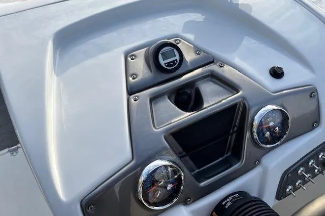 Slide: The Image of 2025 Tahoe 2150 boat dashboard with gauges and controls, featuring a sleek design. - 21