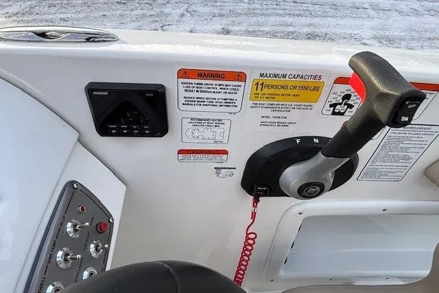 Slide: The Image of Control panel of 2025 Tahoe 2150 boat with capacity and warning labels. - 22