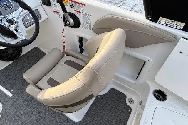 Slide: The Image of 2025 Tahoe 2150 boat interior with beige captain's chair and control panel. - 26