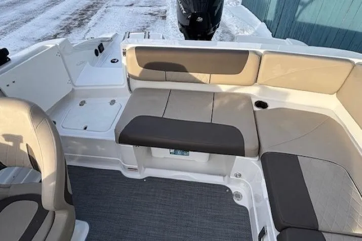Slide: The Image of 2025 Tahoe 2150 boat interior with beige seating and gray flooring. - 31