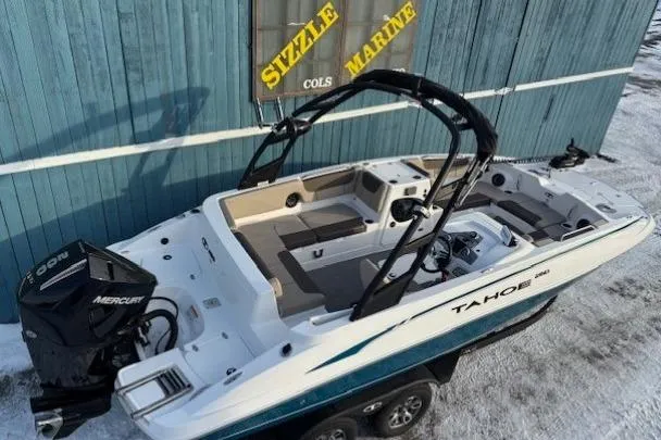 Slide: The Image of 2025 Tahoe 2150 boat with Mercury engine, parked on snowy ground near Sizzle Marine building. - 5