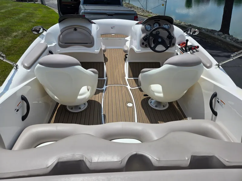 Slide: The Image of 2001 Yamaha Boats LS 2000 interior with steering wheel and seating, docked near water. - 10