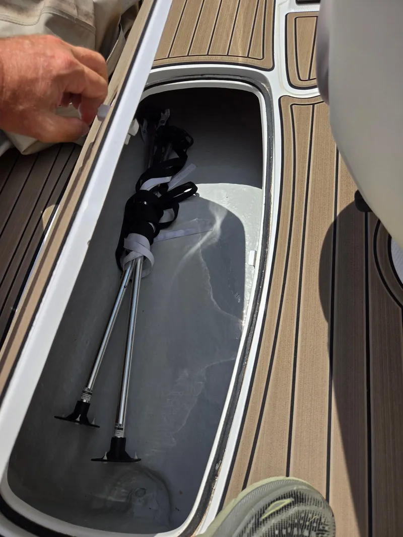 Slide: The Image of Storage compartment on a 2001 Yamaha LS 2000 boat with equipment inside. - 13