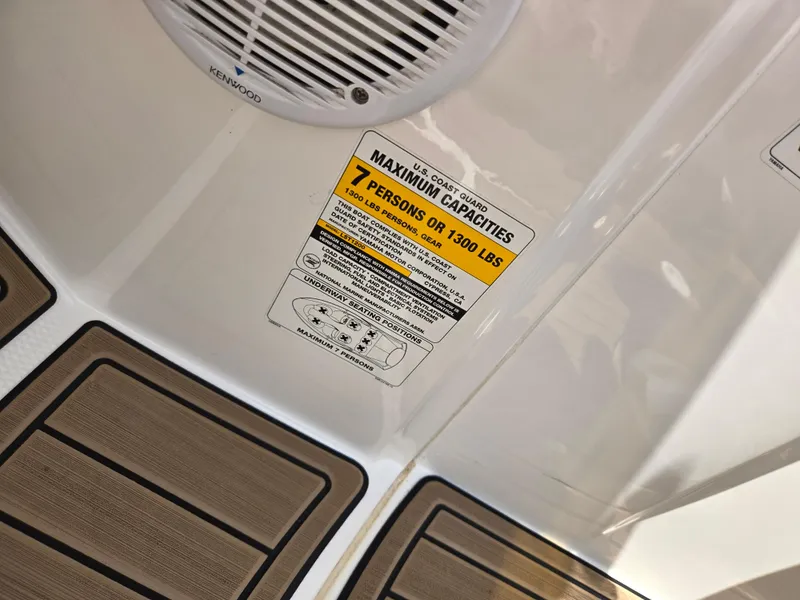 Slide: The Image of 2001 Yamaha LS 2000 boat capacity label, 7 persons or 1300 lbs, Kenwood speaker. - 15