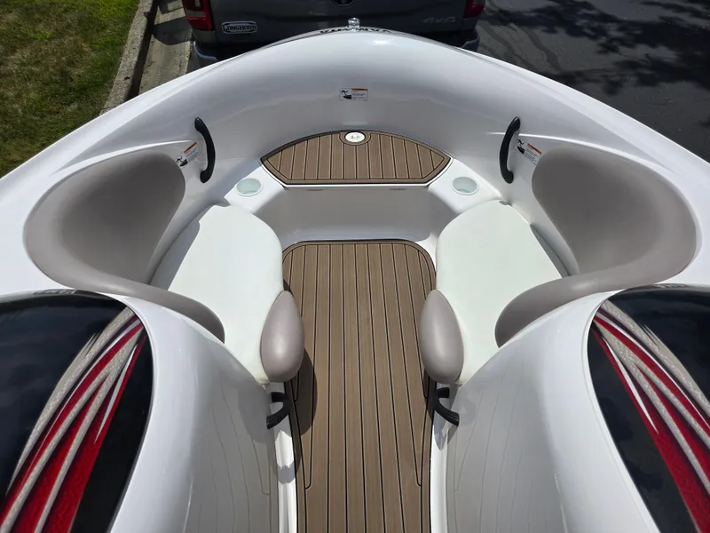 Slide: The Image of 2001 Yamaha LS 2000 boat interior with white seating and wood-style flooring. - 16