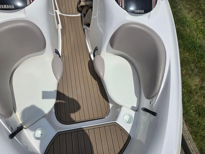 Slide: The Image of 2001 Yamaha LS 2000 boat interior with cushioned seats and wooden flooring. - 17