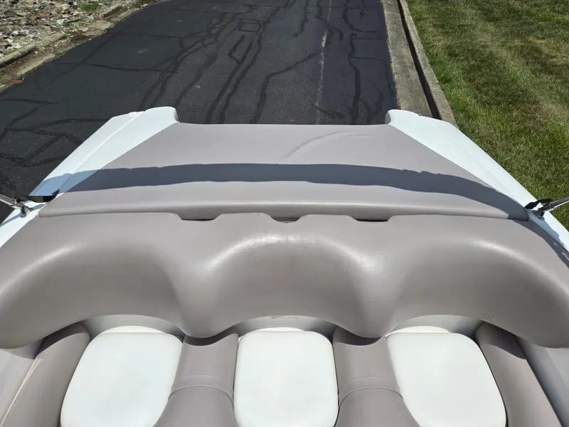 Slide: The Image of 2001 Yamaha Boats LS 2000 interior with gray and white seating, parked on pavement. - 20