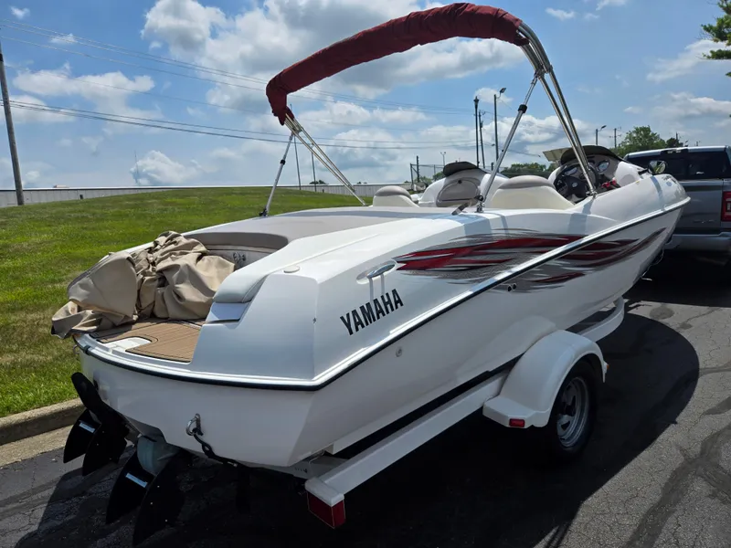 Slide: The Image of 2001 Yamaha LS 2000 boat on trailer, white with red accents, parked outdoors. - 3