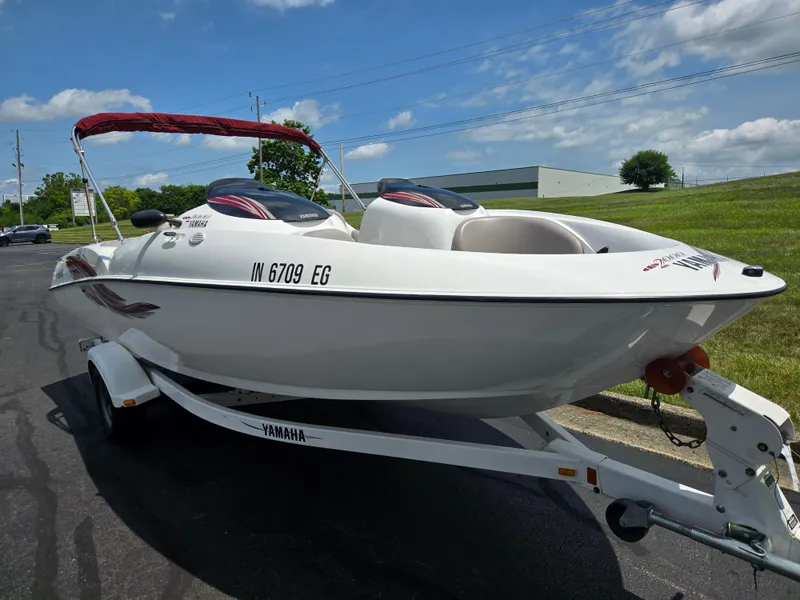 Slide: The Image of 2001 Yamaha LS 2000 boat on trailer, parked outdoors under a partly cloudy sky. - 5