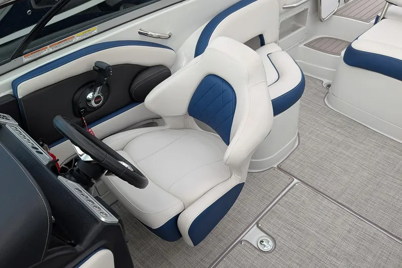 Slide: The Image of 2022 Crownline 260 XSS boat interior with plush seating and modern steering console. - 10