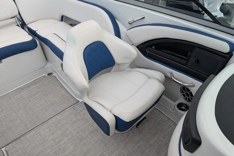 Slide: The Image of 2022 Crownline 260 XSS boat interior with white and blue seating and modern design. - 13