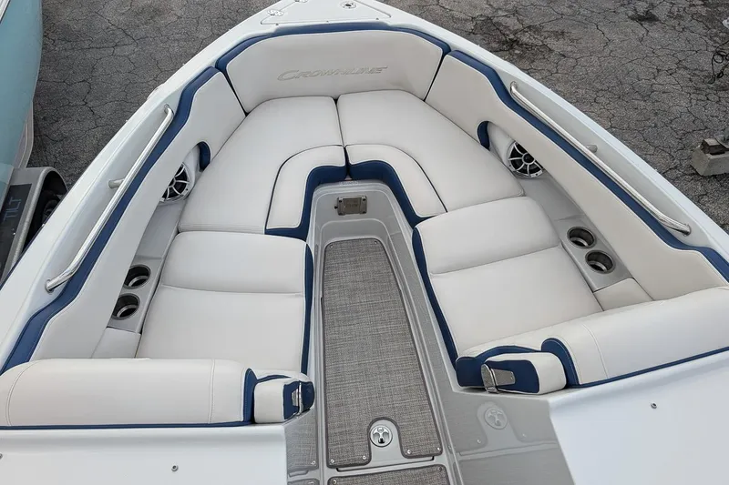Slide: The Image of 2022 Crownline 260 XSS boat interior with white and blue cushioned seating. - 15