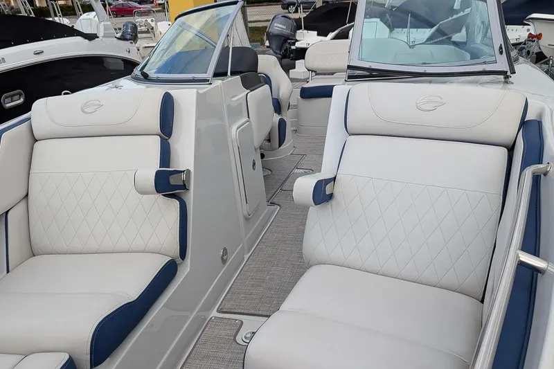 Slide: The Image of 2022 Crownline 260 XSS boat interior with luxurious white and blue seating. - 16