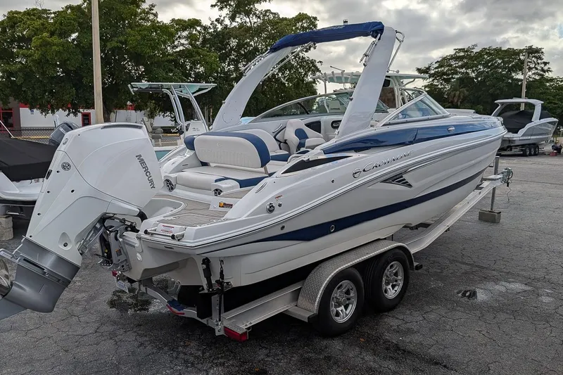 Slide: The Image of 2022 Crownline 260 XSS boat on trailer, featuring a Mercury outboard motor. - 3