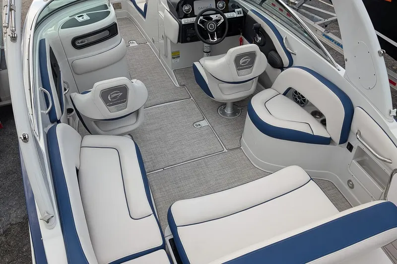 Slide: The Image of 2022 Crownline 260 XSS boat interior with white and blue seating, modern dashboard. - 6