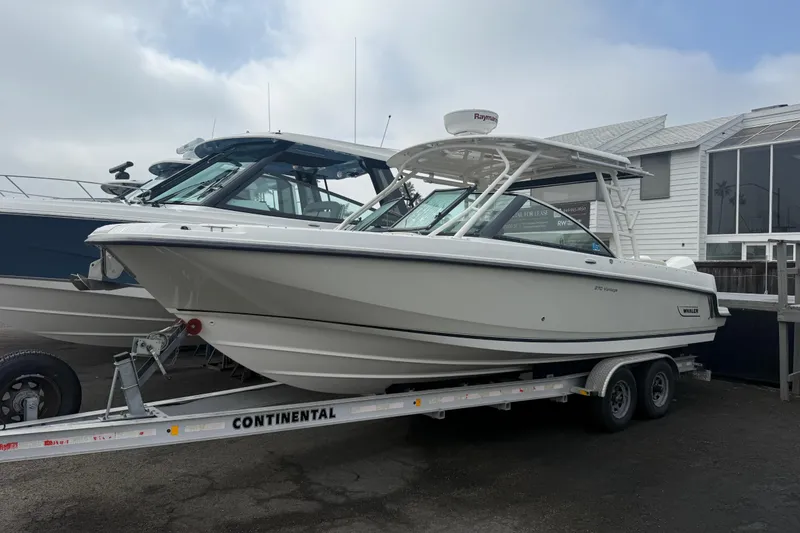 The Image of 2018 Boston Whaler 270 Vantage boat on trailer, parked outdoors. - 1