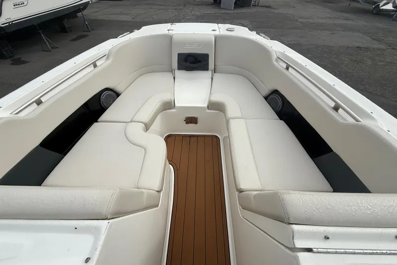Slide: The Image of 2018 Boston Whaler 270 Vantage boat interior with white seating and teak flooring. - 13