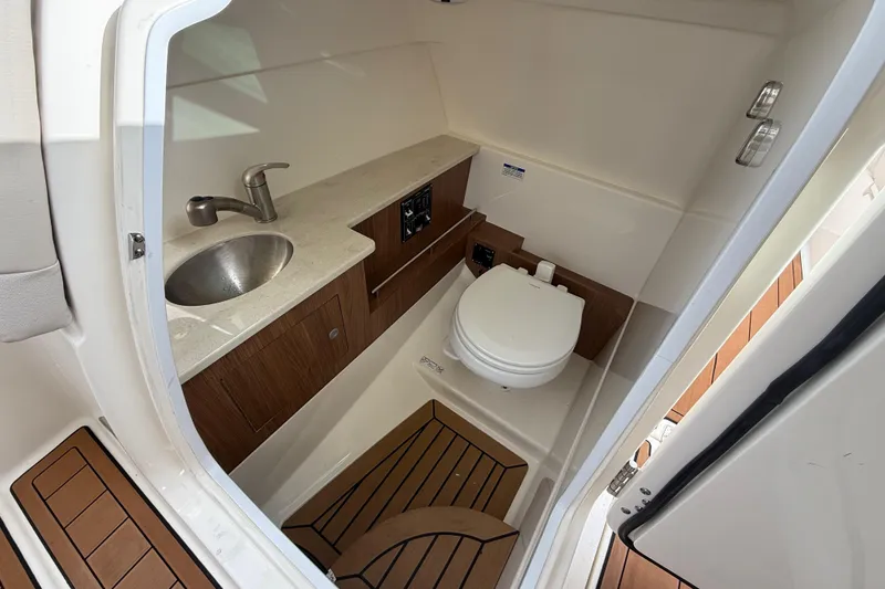 Slide: The Image of 2018 Boston Whaler 270 Vantage boat interior with sink and toilet. - 14