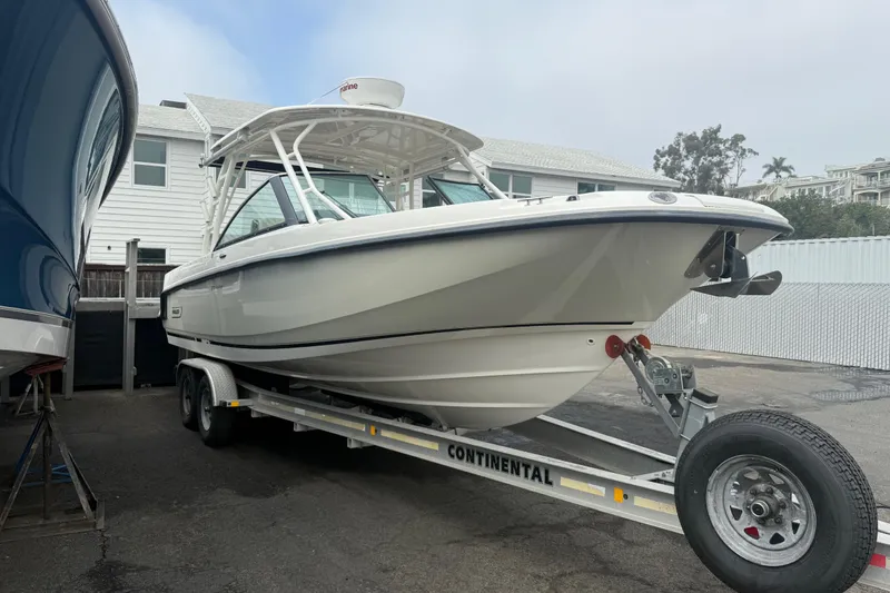 Slide: The Image of 2018 Boston Whaler 270 Vantage boat on trailer, parked outdoors. - 3