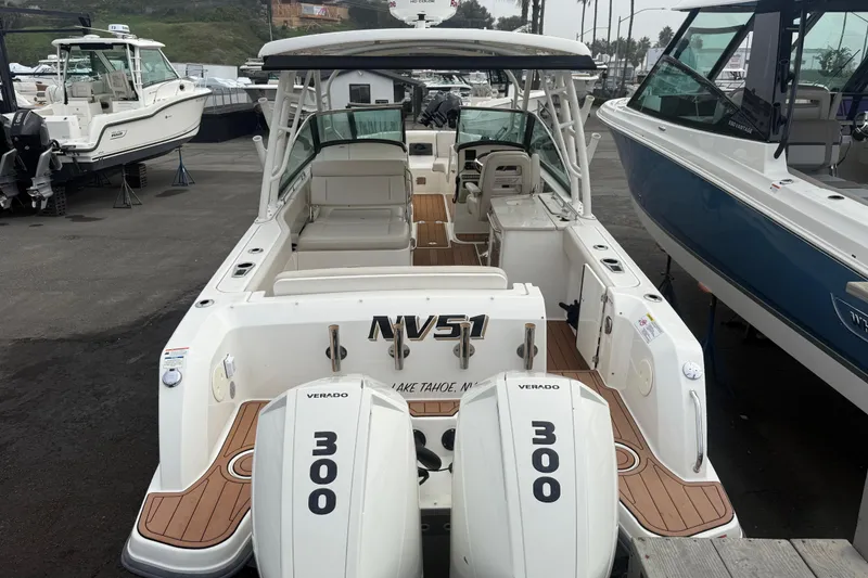 Slide: The Image of 2018 Boston Whaler 270 Vantage boat with twin 300 Verado engines, docked in a marina. - 4