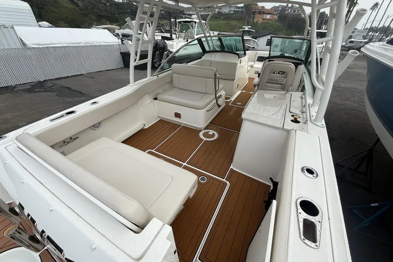 Slide: The Image of 2018 Boston Whaler 270 Vantage boat interior with seating and teak flooring. - 6