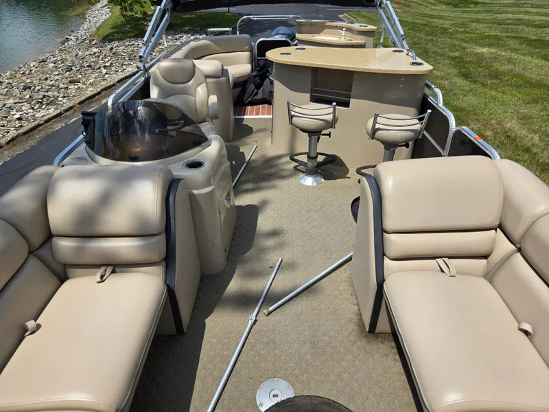 Slide: The Image of 2014 South Bay 522 E pontoon boat interior with beige seating and bar area. - 12