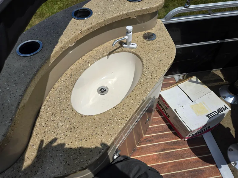 Slide: The Image of 2014 South Bay 522 E boat sink with countertop and propeller box on deck. - 19