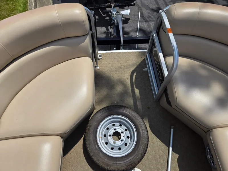 Slide: The Image of Interior of a 2014 South Bay 522 E pontoon boat with seating and a spare tire. - 24