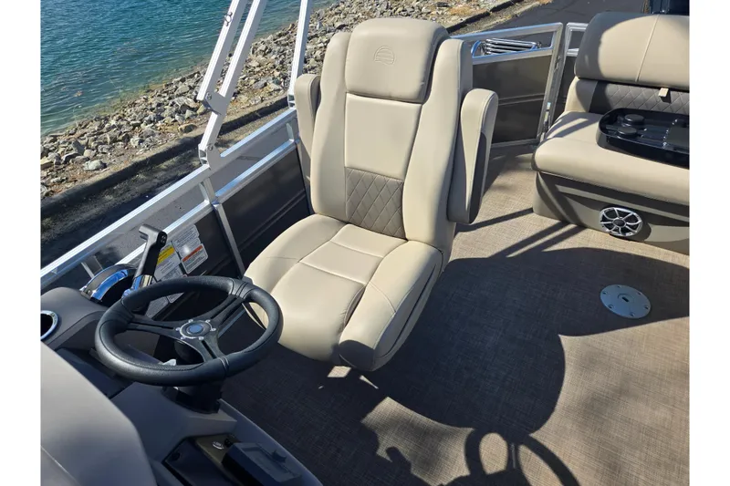 Slide: The Image of 2024 Sun Tracker Party Barge 20 DLX interior with steering wheel and comfortable seating. - 15