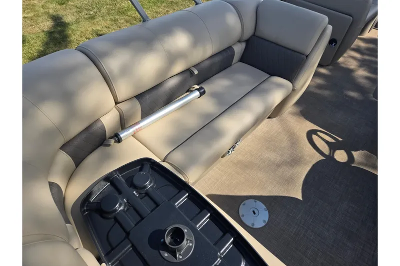 Slide: The Image of 2024 Sun Tracker Party Barge 20 DLX interior with beige seating and table base. - 19