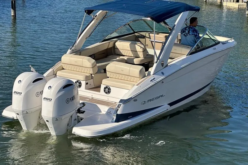 Slide: The Image of 2019 Regal 29 OBX boat with dual Yamaha outboard engines on water. - 10