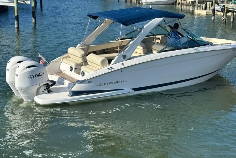Slide: The Image of 2019 Regal 29 OBX boat with Yamaha engines on water, featuring a blue canopy. - 11