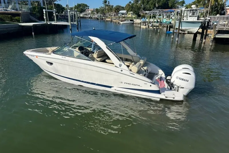 Slide: The Image of 2019 Regal 29 OBX boat with Yamaha engine on a calm waterway. - 2