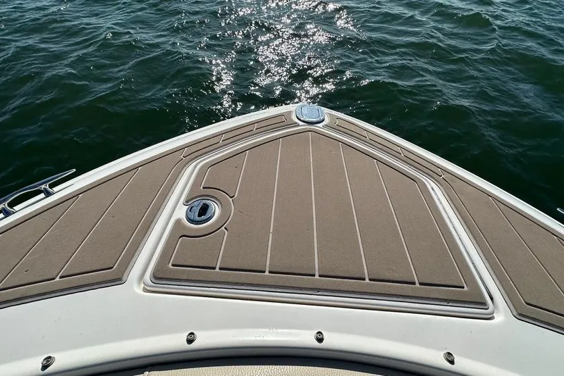 Slide: The Image of Bow of 2019 Regal 29 OBX boat on water, featuring sleek deck design. - 20