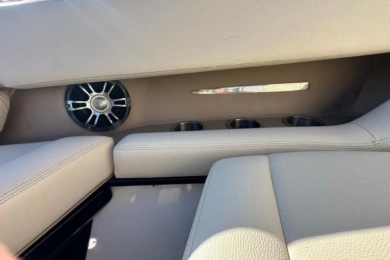 Slide: The Image of 2019 Regal 29 OBX boat interior with speaker and cup holders. - 24