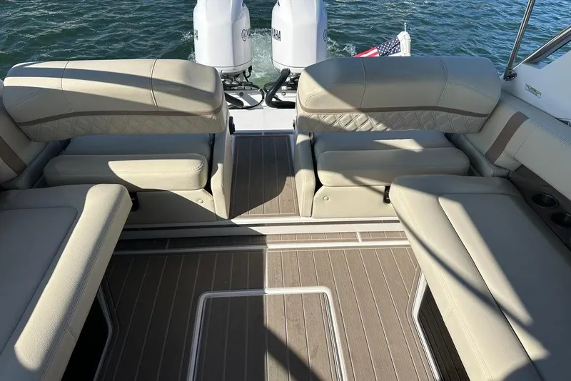 Slide: The Image of 2019 Regal 29 OBX boat interior with beige seating and twin Yamaha engines. - 28