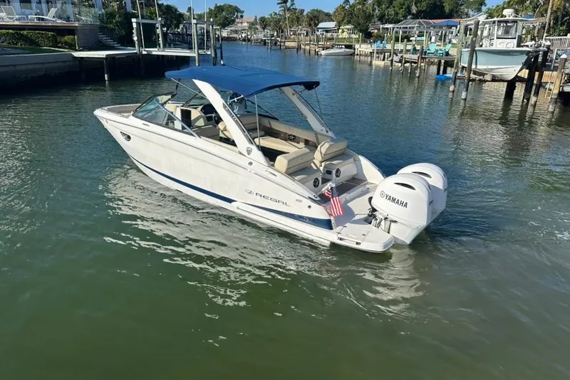 Slide: The Image of 2019 Regal 29 OBX boat with Yamaha engines on a calm waterway. - 3