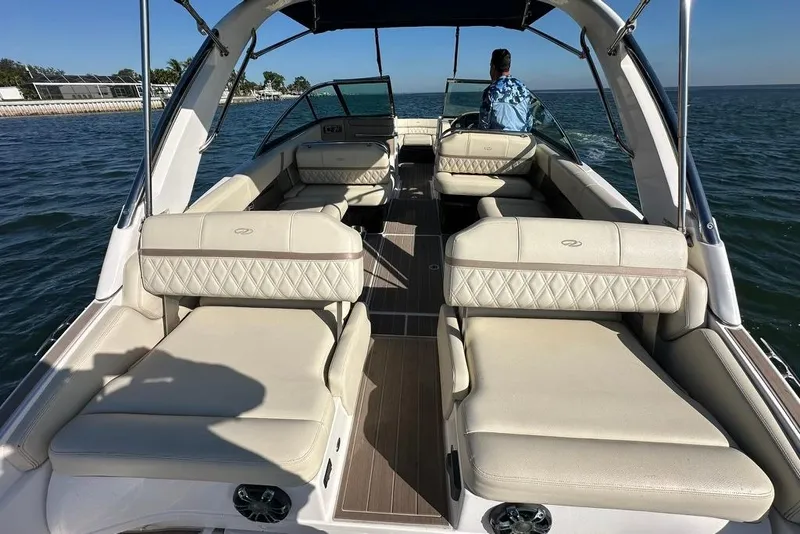 Slide: The Image of 2019 Regal 29 OBX boat interior with luxurious seating on open water. - 30