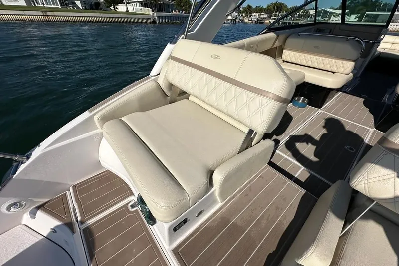 Slide: The Image of 2019 Regal 29 OBX boat interior with beige seating and wooden flooring. - 32