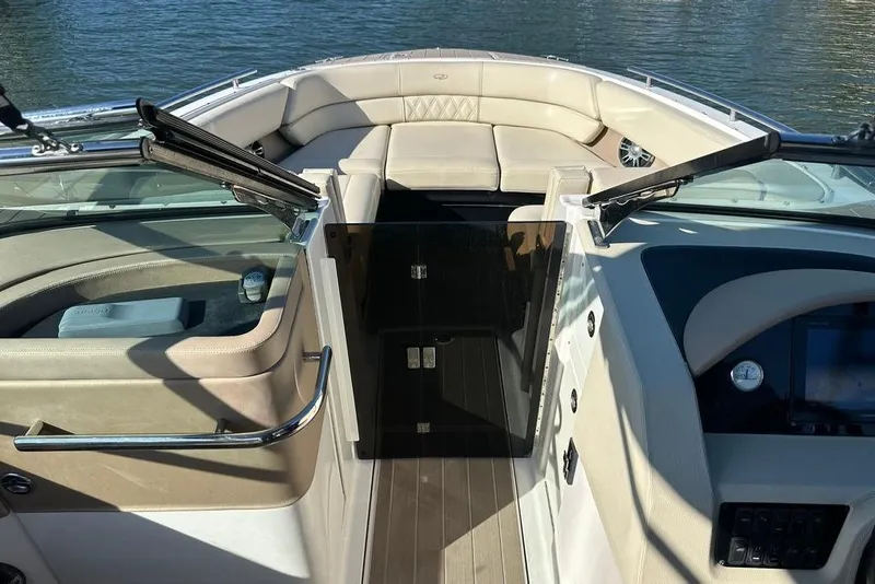 Slide: The Image of 2019 Regal 29 OBX boat interior with beige seating and open windshield. - 36