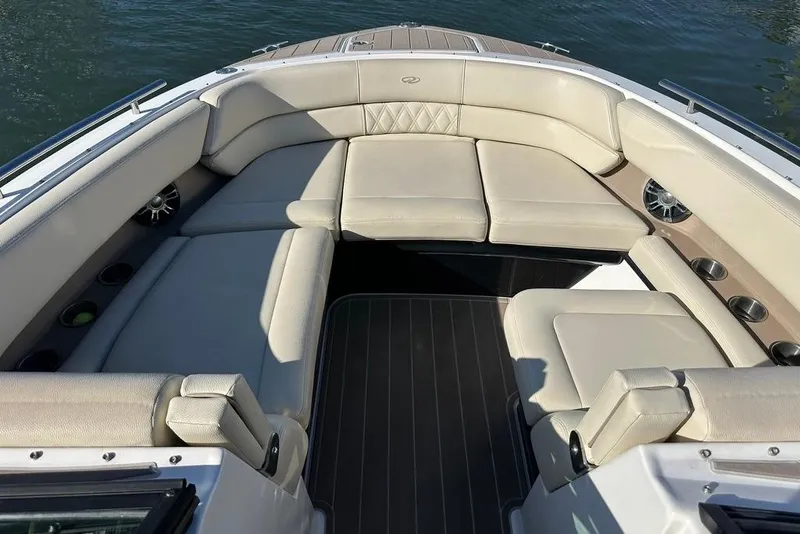 Slide: The Image of Luxurious seating area on a 2019 Regal 29 OBX boat, featuring beige upholstery. - 38